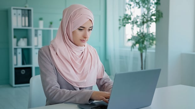 Sad shocked Arabian Indian Muslim Islamic looser businesswoman worker mistake in online document computer error close mouth with hand from failure reading bad news online frustrated losing problem photo