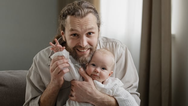 Webcam view portrait caucasian bearded dad and infant newborn small girl little kid daughter son waving hands greeting talking to camera call at home. Closeup father with little child conference photo