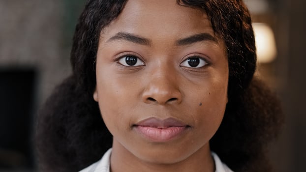 Female portrait indoors alone serious calm confident African American businesswoman intern student girl with perfect skin woman looking at camera in office workspace at home bullying racism feminism photo