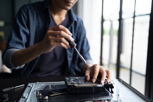 Engineer installing Hardware. man is working on a computer with a screwdriver photo
