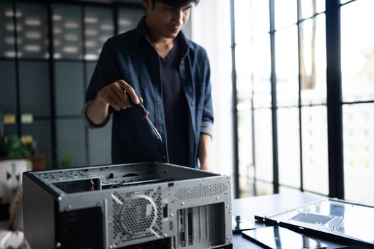 a man is fixing a computer case. Engineer installing Hardware photo