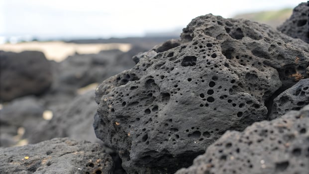 Rough Porous Texture of Black Volcanic Rock with Irregular Formations photo