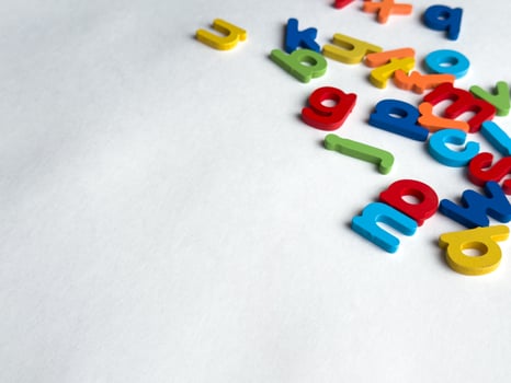 Colorful magnetic letters on white background for education and learning photo