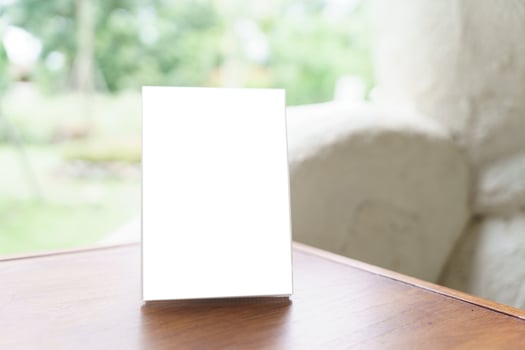 a Menu mock up blank white card on a table in front of a window photo