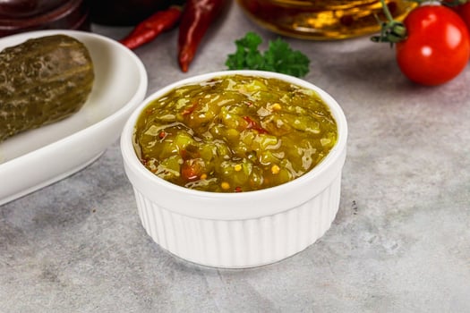 Souce gherkin relish with marinated cucumbers photo