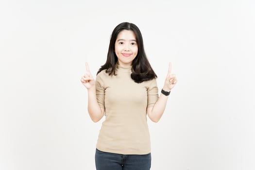 Showing Product and Pointing Up Of Beautiful Asian Woman Isolated On White Background photo