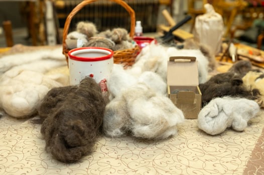 Wool fibers for crafting with basket, yarn, and natural materials on display photo