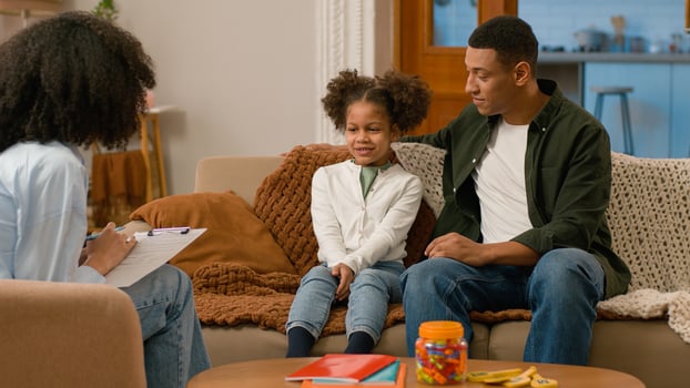 African American family together psychologist doctor writing man father dad tell parenting childcare daughter kid child dialogue conversation advice relations psychotherapy ethnicity preteen offspring photo
