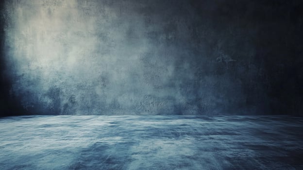 Large empty room with a grey wall. The room is empty and has a very cold and empty feeling photo