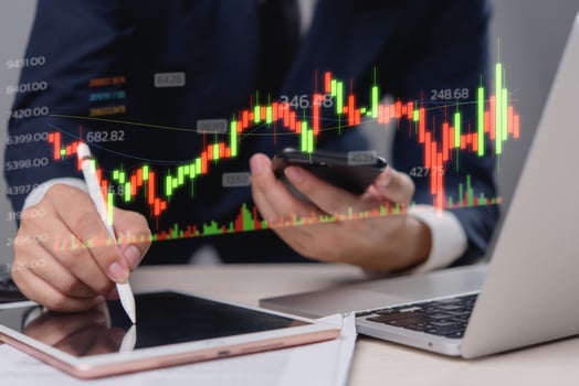 Man using tablet and pen to draw stock market chart photo
