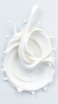 Swirling white cream creating dynamic splashes against a light background illustrating movement and fluidity photo