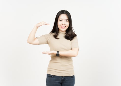 Measuring and Showing Big Sign Product Of Beautiful Asian Woman Isolated On White Background photo