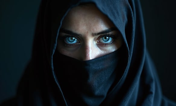 Striking blue eyes black niqab dramatic lighting intense photo