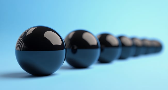A row of black balls on a blue background photo