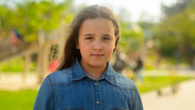 Portrait little girl child adopt kid innocence face adorable daughter smiling happy schoolgirl pupil school student in park city outdoors looking at camera health insurance pediatric custody childhood photo
