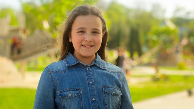 Portrait little girl child adopt kid innocence face adorable daughter smiling happy schoolgirl pupil school student in park city outdoors looking at camera health insurance pediatric custody childhood photo