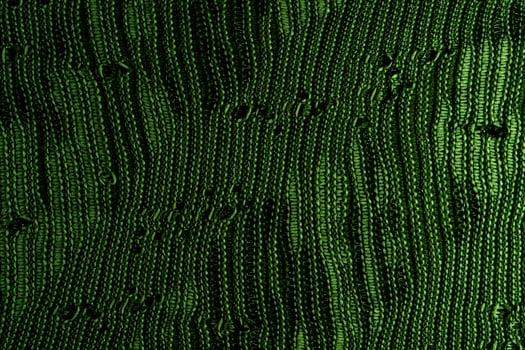A close-up of green knitted fabric texture, detailed pattern, and vibrant color, suitable for backgrounds. photo