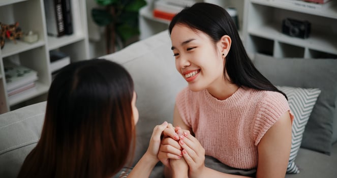 High angle view, Lesbian couple talking and sharing moments of love and happiness together on the sofa in the living room at home. LGBTQ Lifestyle. photo