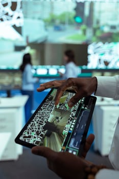 African american manager overseeing delivery truck drivers activity, uses a tablet to monitor traffic on satellite navigation. Operator sends gps coordinates to couriers, delivery service. Close up. photo