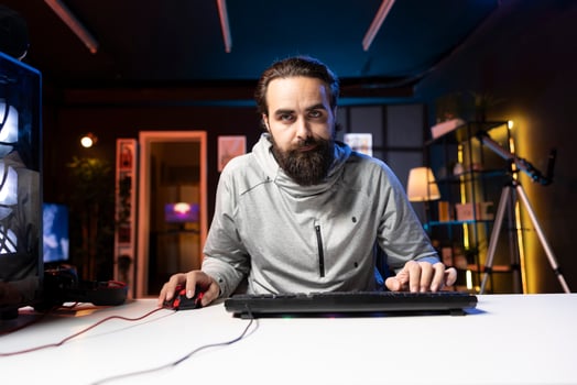 Man using gaming mouse and keyboard to play entertaining videogame, moving character. Pro gamer using professional computer peripherals to enjoy relaxing game at home, having fun photo