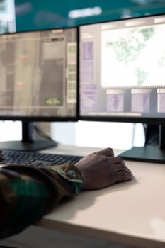 IT operator working on reconnaissance activity mission to gather important data, supporting deployed troops with battlefield information. Serviceman in military base monitoring room. Close up. photo