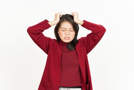 Headache Gesture Of Beautiful Asian Woman Wearing Red Shirt Isolated On White Background photo