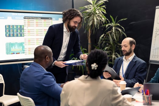 Project leader joins in a conference room with his management team to go over details on legislative shifts that might influence their duties. Director highlighting reports with collected data. photo