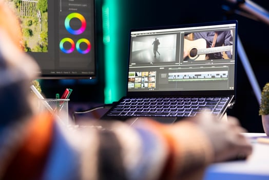 editor working on creative software to create a film montage, using color correction wheel and adding visual effects. Male creator editing gradient for movie post production, white balance. photo