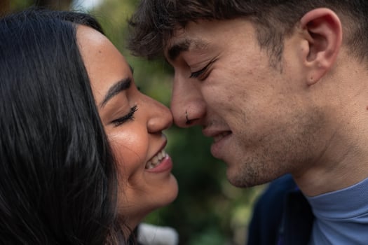 portrait of young multiethnic latin caucasian couple kissing photo