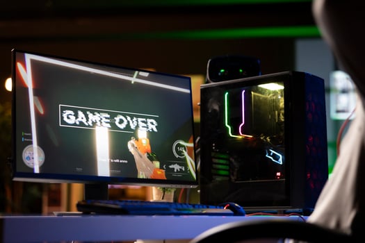 Upset gamer feeling depressed after losing online competitive multiplayer match, playing on gaming setup. Player feeling angry and shouting after being defeated in videogames photo