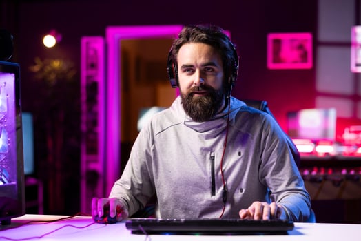 Person using headphones microphone to talk with teammates while playing FPS videogame with gun shooting laser bullets. Gamer chatting with internet friends while enjoying SF game, having fun photo