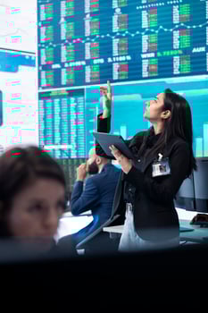 Chief financial officer studying capital funds and revenue data on big screen, verifying annual reports and budget allocation for a project. Looking for ways to increase profit. photo