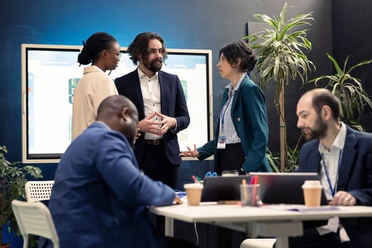 Team members from a business enterprise discussing insight of new project during a corporation meeting. Diverse coworkers stay informed about industry developments and legal decrees. photo