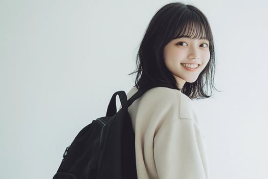 A young woman with a backpack smiling photo