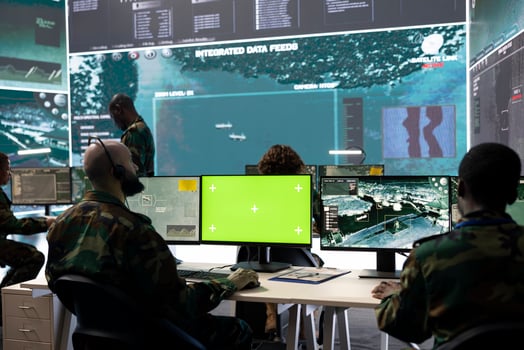 Military personnel works with isolated mockup screen and surveillance footage, monitoring important satellite information. Soldier examines CCTV reconnaissance imagery to aid troops. photo