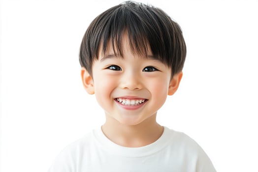 A little boy is smiling and looking at the camera photo