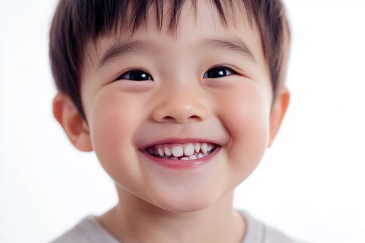 A young boy smiles for the camera photo
