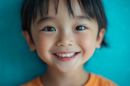 A little girl with blue eyes smiles at the camera photo