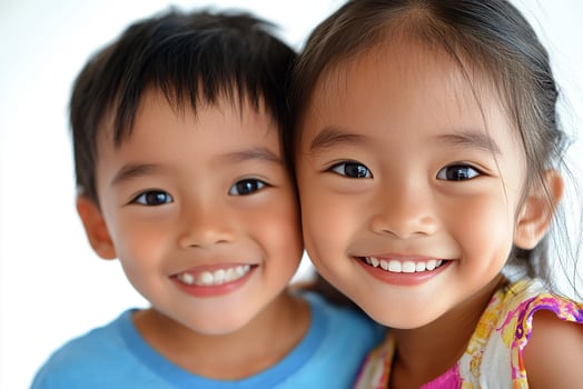 Two young children are smiling for the camera photo