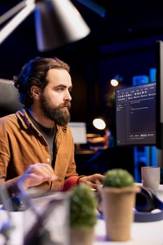 Computer technician securing company servers from DDoS attacks to avoid unwanted failures. IT specialist typing on keyboard, writing code to build firewalls protecting data from threats photo