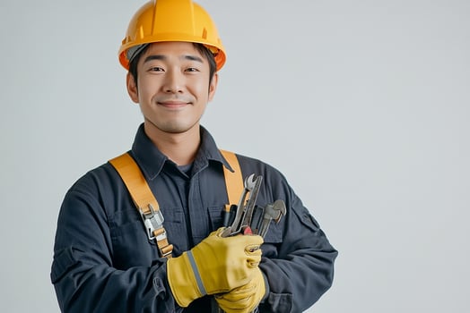 Asian male construction worker holding tools photo