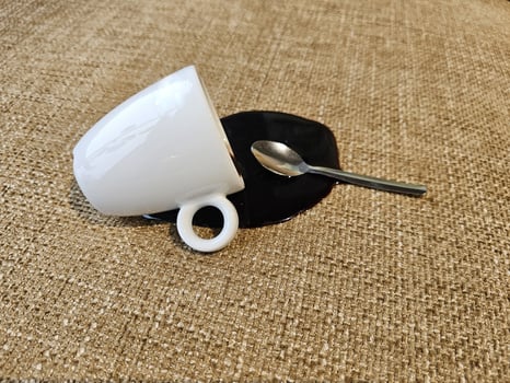 a coffee cup and spoon on a table photo