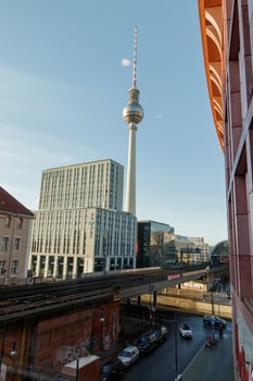 Berlin, Germany, 2019 - tv tower dominating skyline on a sunny winter day with elevated train tracks in the foreground photo
