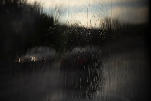 Wet glass. Jets of rain on the glass. Spray on the window. Rain on the street. photo