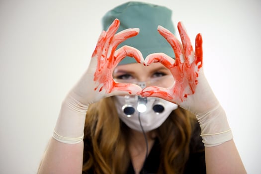 Hands of doctor woman holding red heart, showing symbol of love, human support to patient, promoting medical insurance, early checkup for healthcare, cardiologist help. Close up of object photo