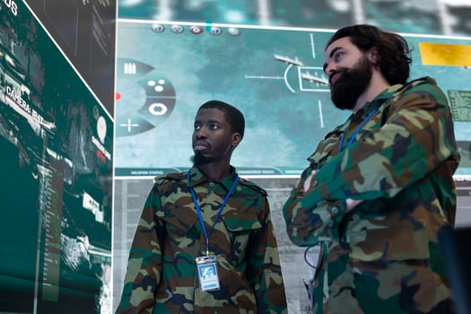 Diverse team of infantry unit soldiers analyzing crucial real time data on a big screen, gather intelligence to support troopers during field operations. Reconnaissance specialists work on espionage. photo