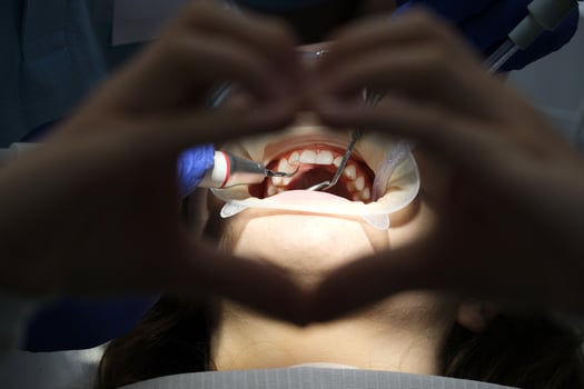 Attractive young woman with natural white teeth in dental clinic. Hands doctor dentist with medical tools. Healthy teeth concept photo