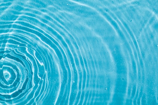 drops on water with circles on a blue background photo