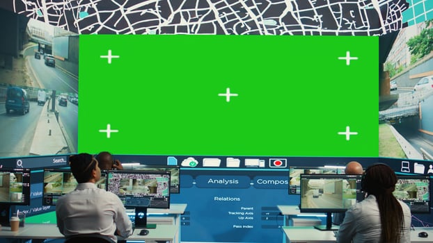 Shipping employees analyzing city map with big isolated display, monitoring delivery trucks with order tracking awb for clients. People using surveillance CCTV system to get updates. Camera B. photo