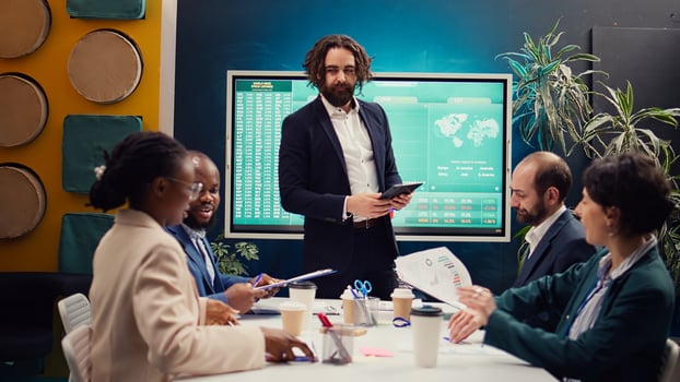 Project manager welcoming his team in business meeting, shaking hands. Supervisor explains the overall enterprise goals, analyzing the current situation and works through planning details. Camera B. photo